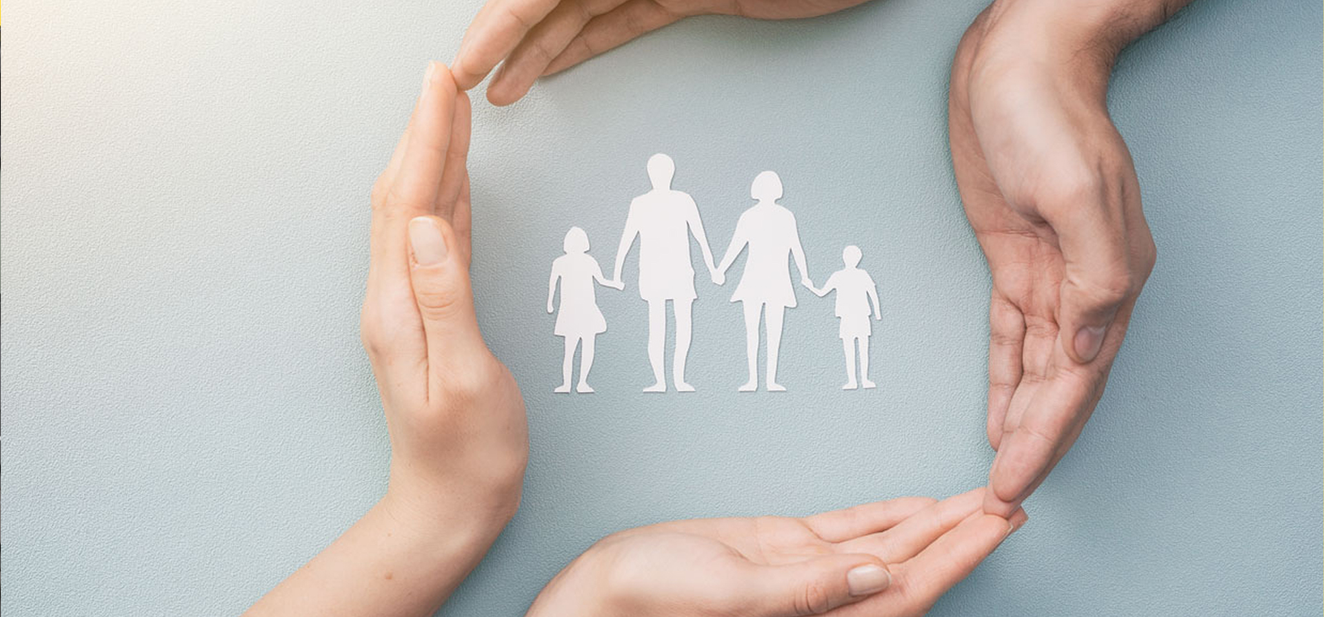 Image showing hands with cut out paper silhouette on table